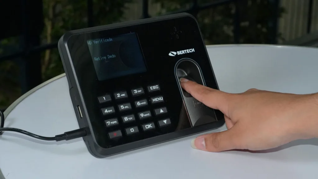 Dedo marcando en el lector del reloj biométrico de huella BT-4, que confirma la huella en la pantalla.